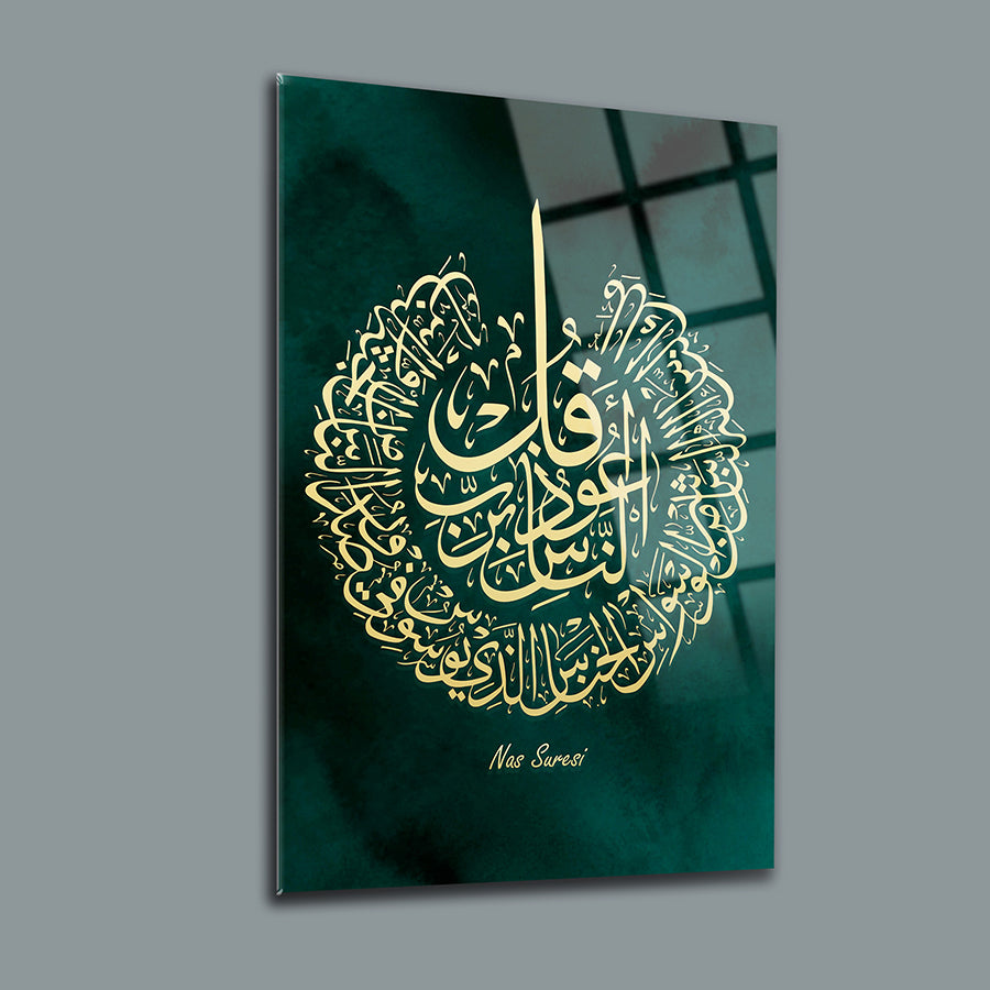 Elegant glass artwork featuring Nas Suresi in intricate Arabic calligraphy on a green background.