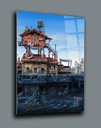 Unique artwork featuring a surreal building with a colorful upper structure and darker lower levels, displayed on glass.