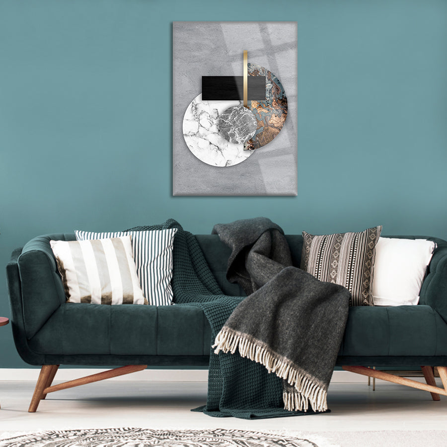 Mermer Dünya Cam Tablo on stylish green wall above modern sofa with cozy blankets and cushions.