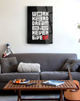 Motivational glass art 'Work Hard Dream Big Never Give Up' displayed above a modern sofa and coffee table.