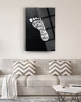 Black glass art with the quote 'Success starts with the first step' displayed above a stylish sofa.