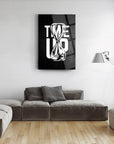 Modern black and white glass wall art featuring an hourglass design with the text 'TIME UP' in a stylish living room.