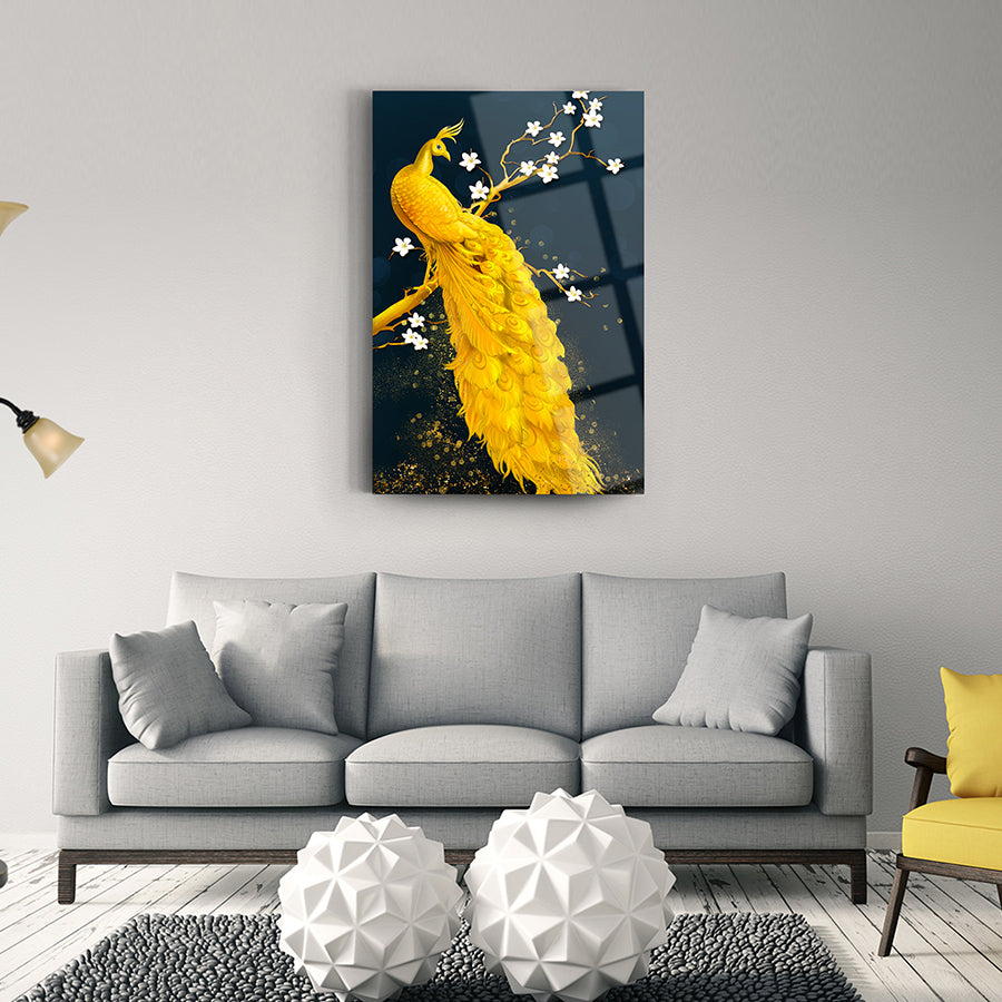 Elegant yellow peacock glass art on a wall above a modern gray sofa in a stylish interior.