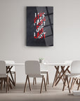 Modern glass wall art with 'Live Fast Die Last' text in a stylish setting, perfect for contemporary decor.