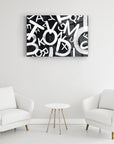 Modern black and white alphabet glass art piece displayed in a stylish seating area.