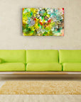 Colorful mandala glass painting on a living room wall above a green sofa, adding artistic flair to home decor.
