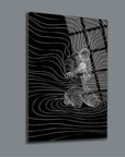 Abstract design of a kneeling figure in flowing lines on black glass, perfect for modern home decor.
