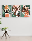 Afrikalı Kadın-2 3'lü Set Cam Tablo; modern sanat, sıcak renkler, tropikal yapraklar, zarif tasarım.