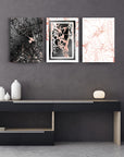 Stylish Mermer Desen 3'lü Set Cam Tablo displayed on a modern wall with a sleek black cabinet.