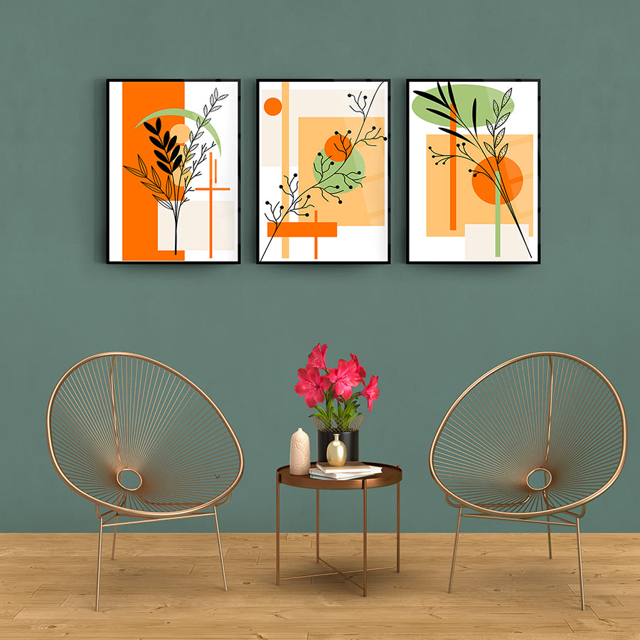 Modern three-panel glass artwork set featuring abstract plant designs on a stylish wall.