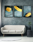 Elegant 3-piece glass art set with golden textures, enhancing modern living room decor.