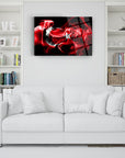 Modern abstract red smoke art print displayed above a white sofa in a cozy living room setting.