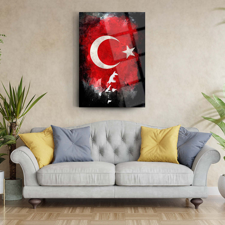 Atatürk and Turkish flag glass wall art on a living room wall above a gray sofa with colorful cushions.