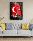 Atatürk and Turkish flag glass wall art on a living room wall above a gray sofa with colorful cushions.