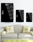 Modern glass art decor with dimensions displayed on a wall above a stylish sofa in a living room.