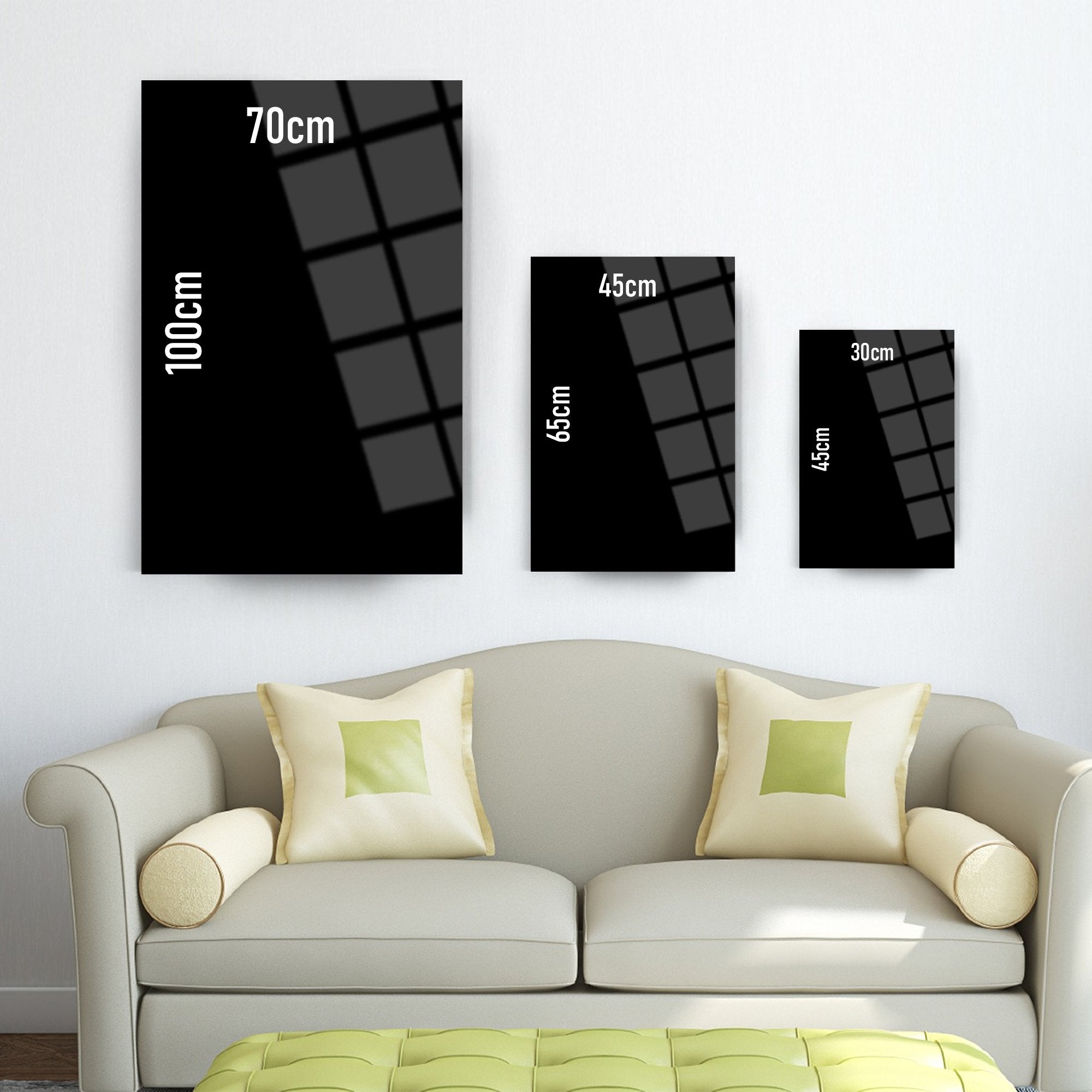 Modern wall art sizes displayed above a stylish sofa in a bright living room.
