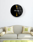 48 cm cap black round glass wall art above a light green sofa with pillows.