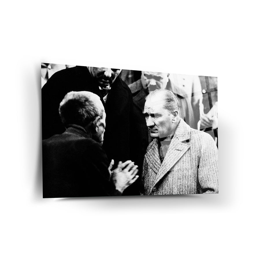 Black and white photo of two men engaged in a serious conversation, depicting a historical moment.