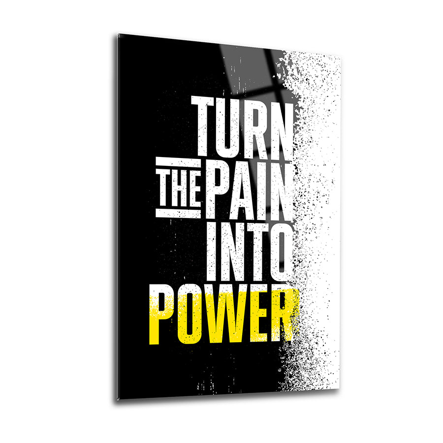 A modern glass artwork featuring the motivational phrase 'Turn the Pain Into Power' in bold lettering.