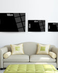 Three black framed wall art sizes (100cm, 70cm, 45cm) displayed above a stylish couch.