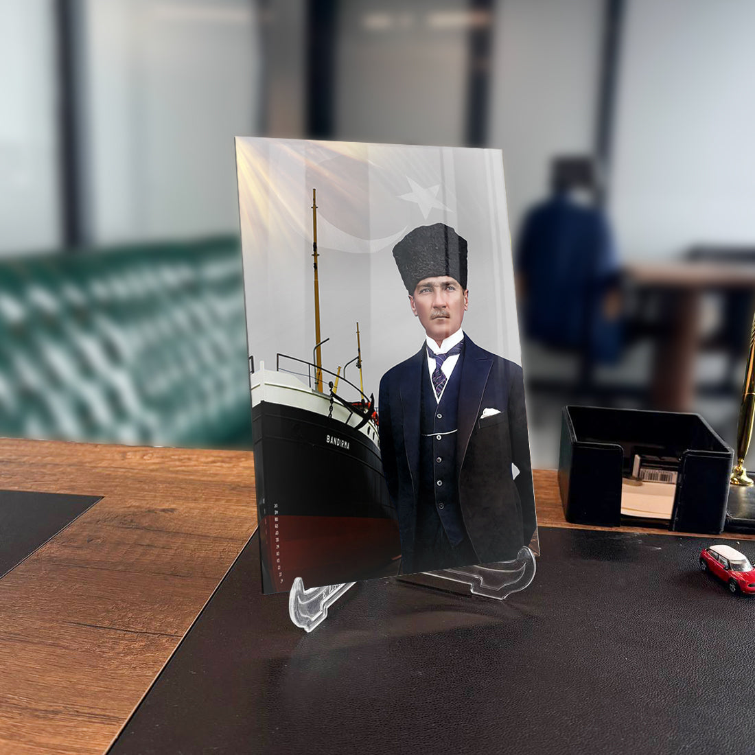 Atatürk glass panel artwork displayed on a desk, featuring a historic ship in the background.