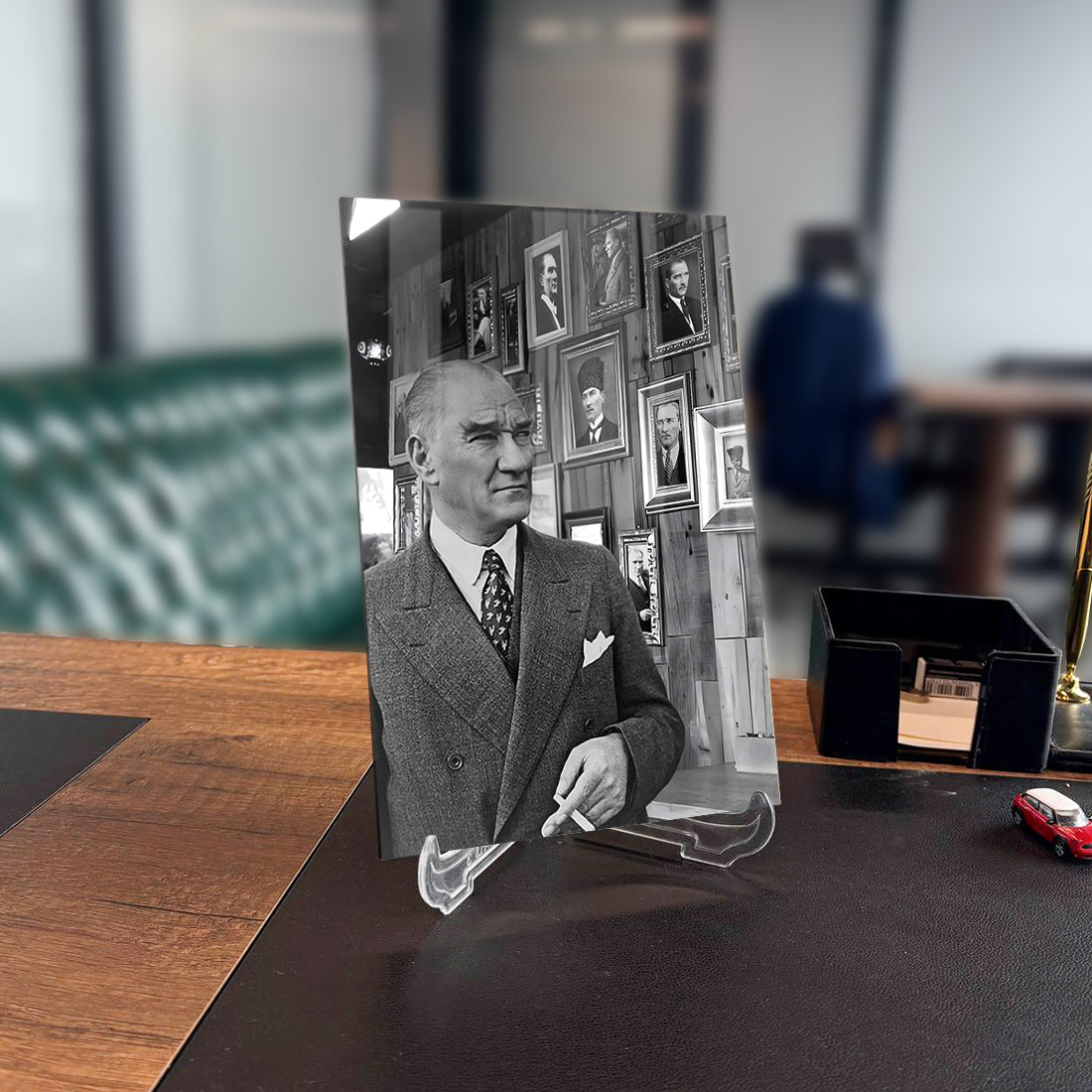 Atatürk 122 Cam Tablo displayed on a desk with vintage setting and background portraits.