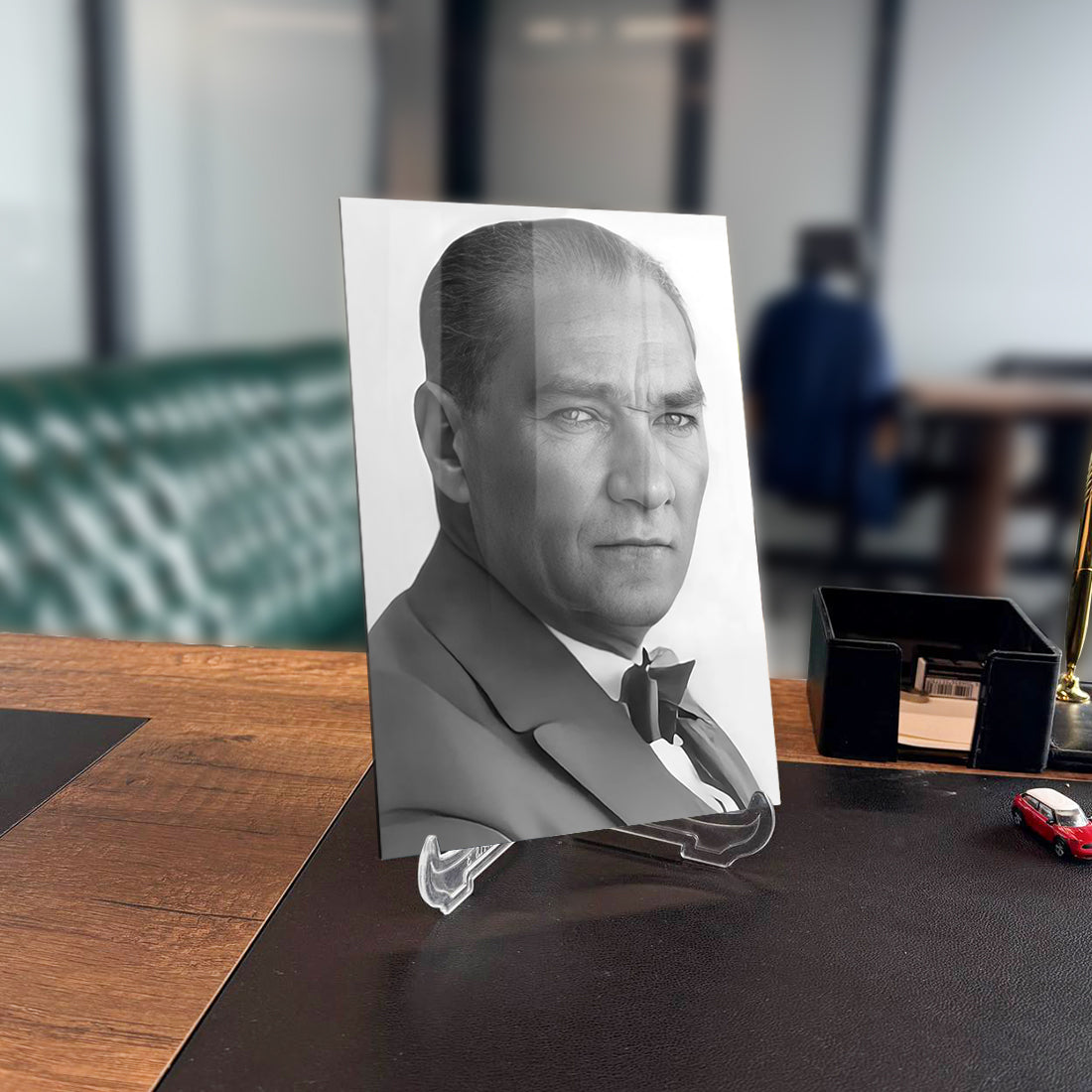 Atatürk 217 Cam Tablo featuring a black and white portrait displayed in an office setting.