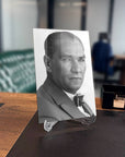 Atatürk 217 Cam Tablo featuring a black and white portrait displayed in an office setting.
