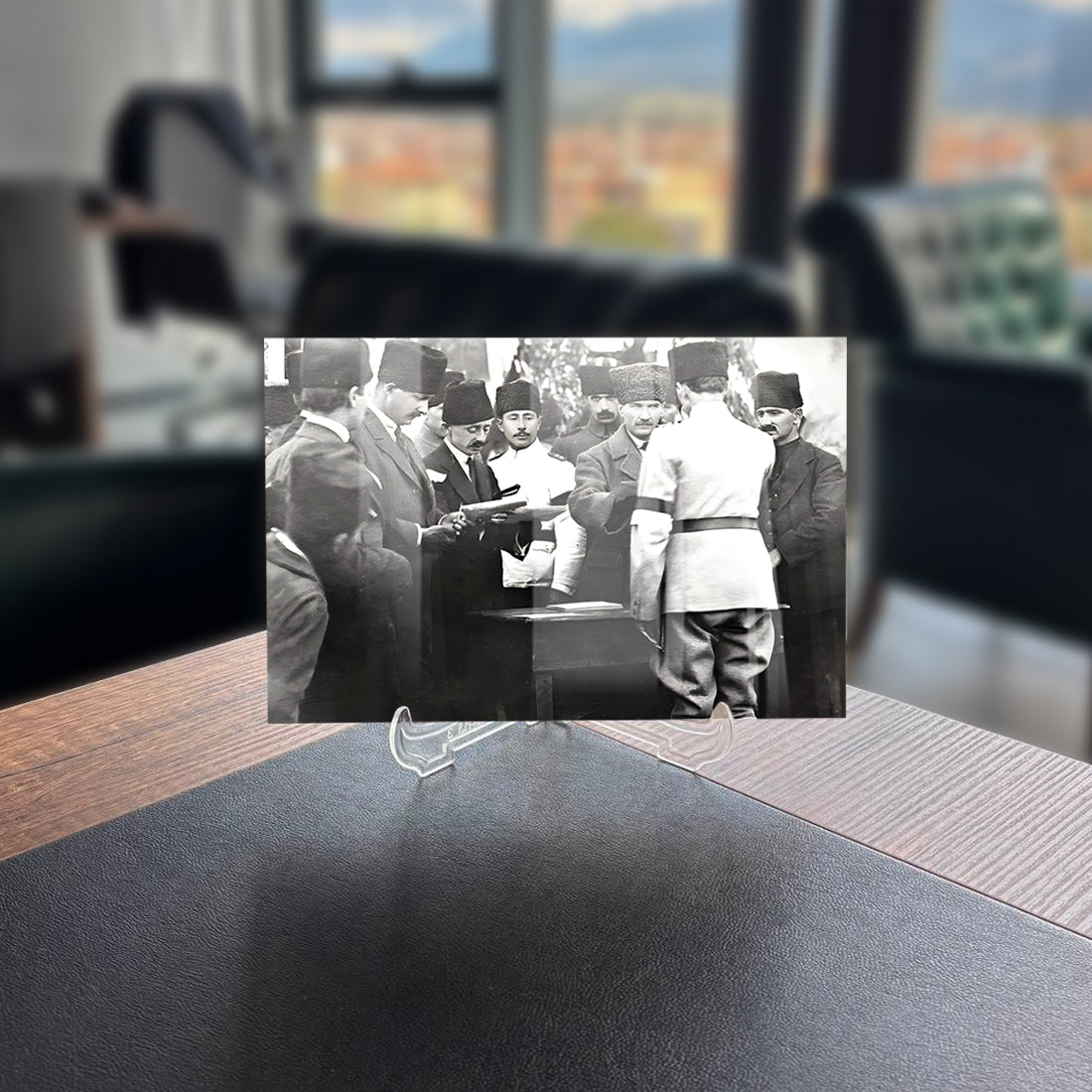 Historical black and white photo of officials in Ankara discussing at a table, showcasing Atatürk's era.