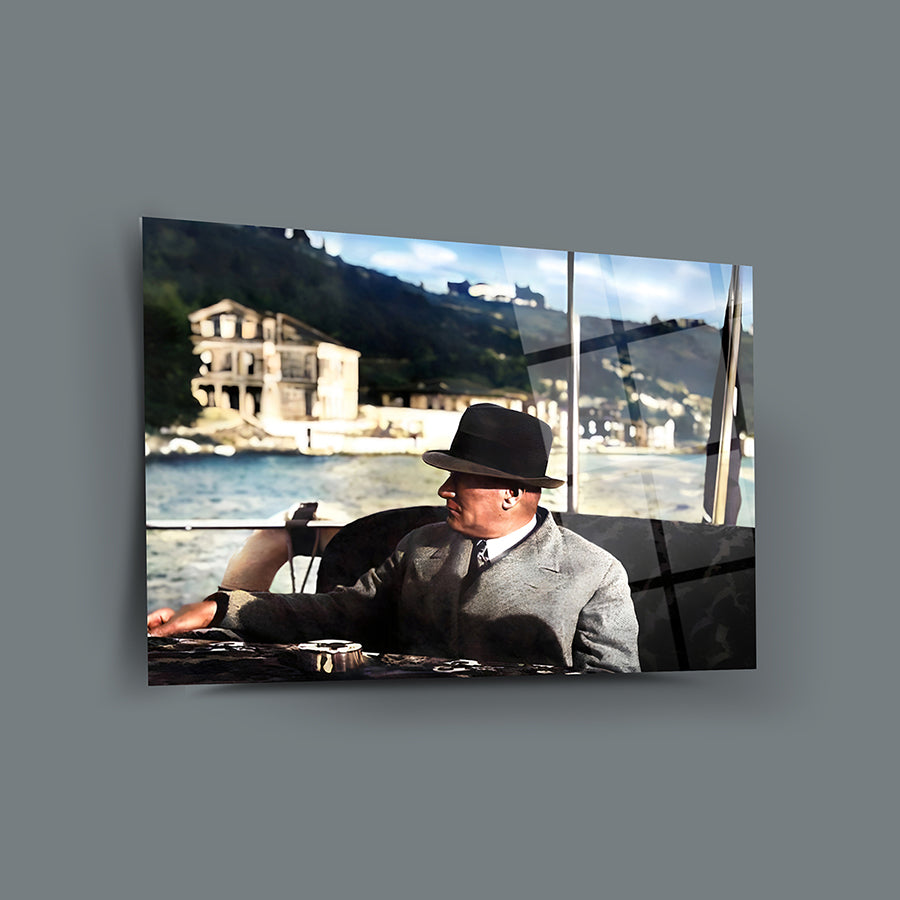 Atatürk 194 Cam Tablo featuring a man in a hat near a lake with a historic building in the background.