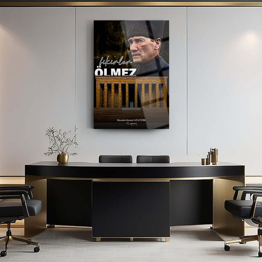 Modern office interior featuring a motivational poster with the phrase 'Fikirler Ölmez' and a portrait of a historical figure.