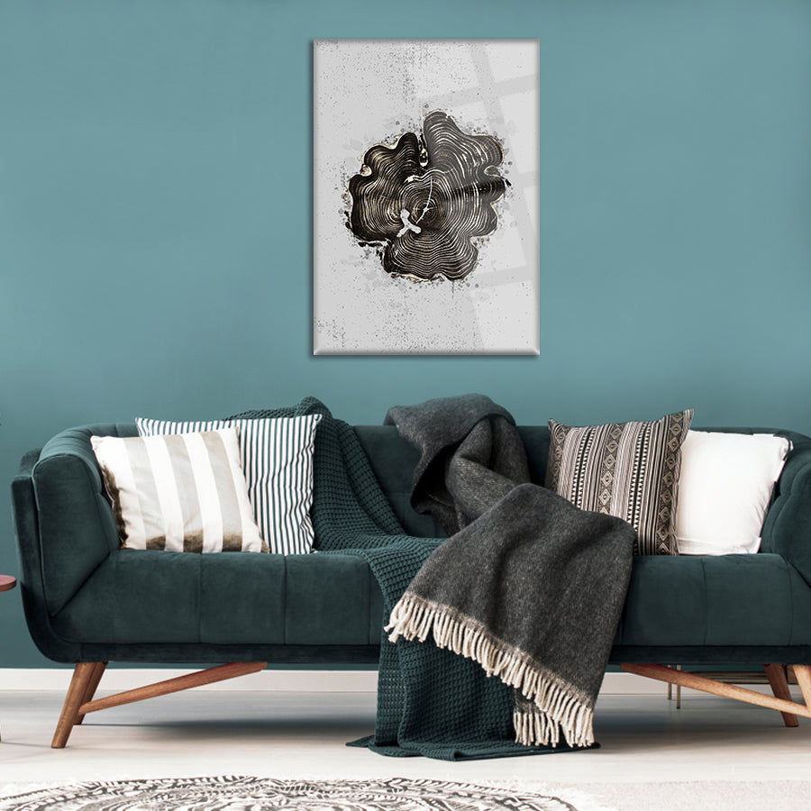 Realist Ağaç Cam Tablo displayed above a cozy green sofa with patterned pillows and a warm blanket.